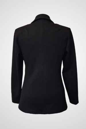 Atramentum tailored pantsuit in black, showcasing its form-fitting silhouette, princess seams, and open lapel for a structured, elegant look.