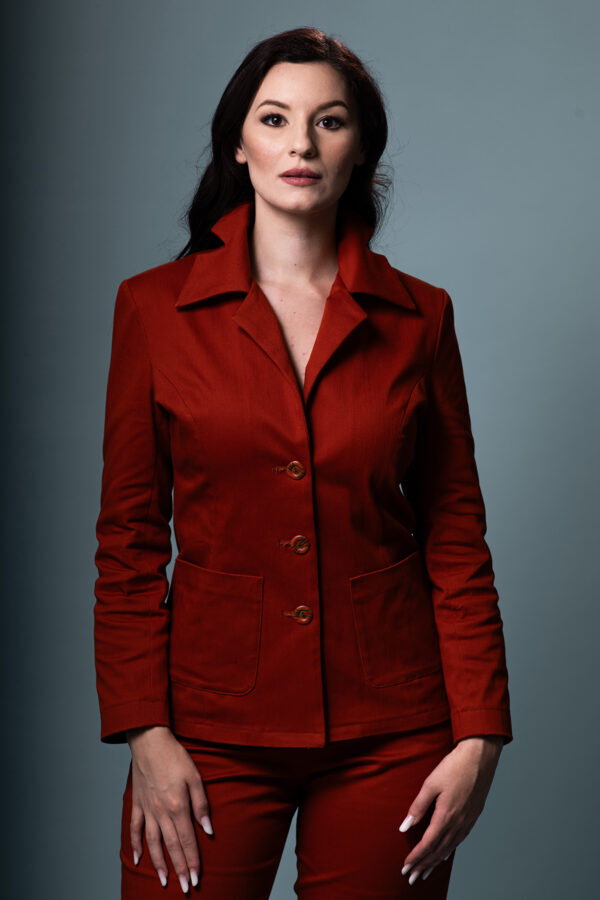 Terracina tailored pantsuit in terracotta with sharp lapel, front view.