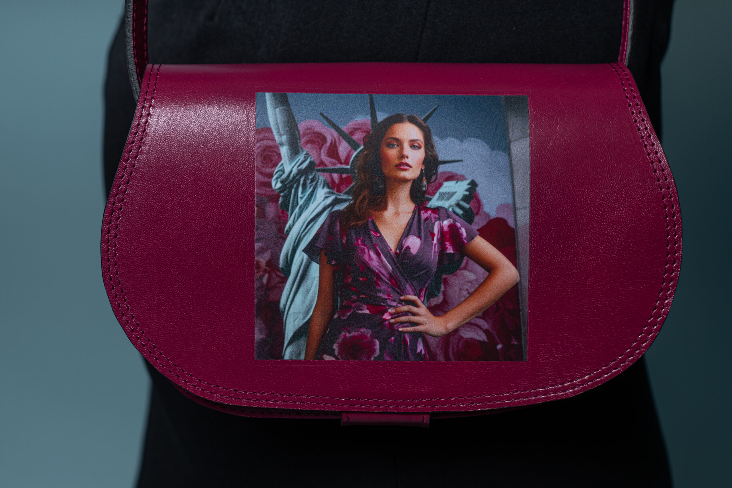 Detail of AI-generated print on cranberry goat leather handbag with cotton lining.