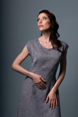 Detail of soft grey and white striped linen fabric on the Luna Alba dress, showing artisanal craftsmanship.