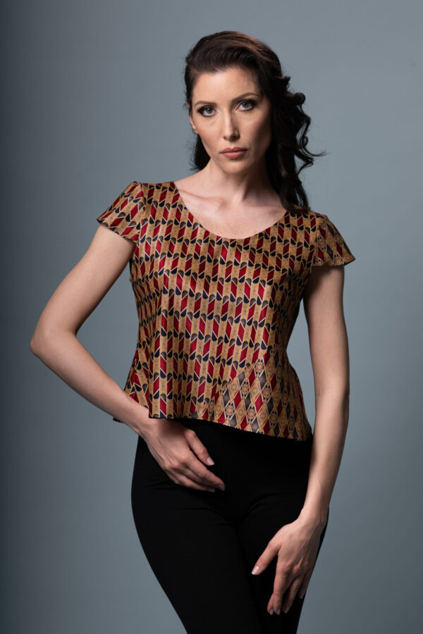 Astrum Sericum silk top styled in a sophisticated setting, emphasizing its artistic print and luxurious fabric.