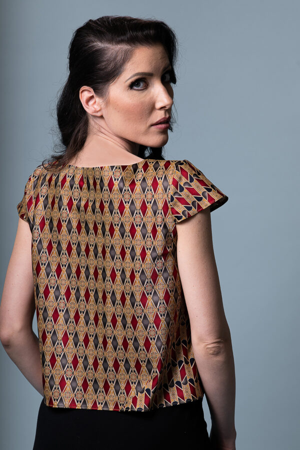 Back view of the Astrum Sericum bias-cut silk top, showcasing its fluid drape and asymmetric print.